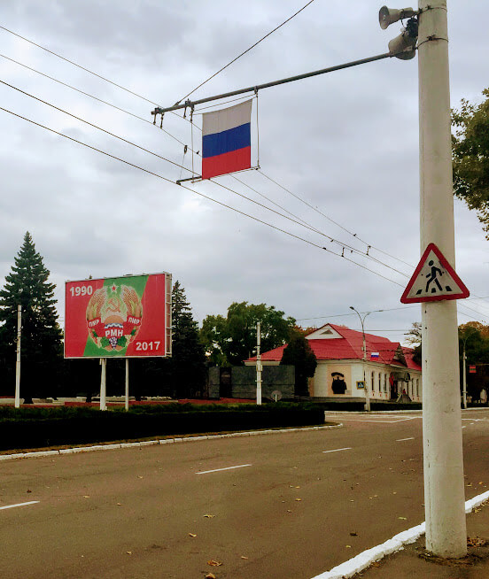 Billboard celebrating 27 years of Transnistria independence next to Russian flag.