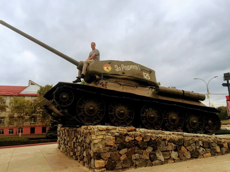 man riding on barrel of a Russian tank in Transnistria