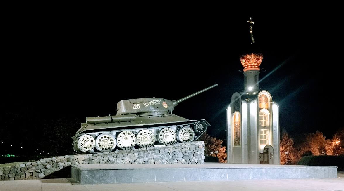 Russian tank on pedestal at night