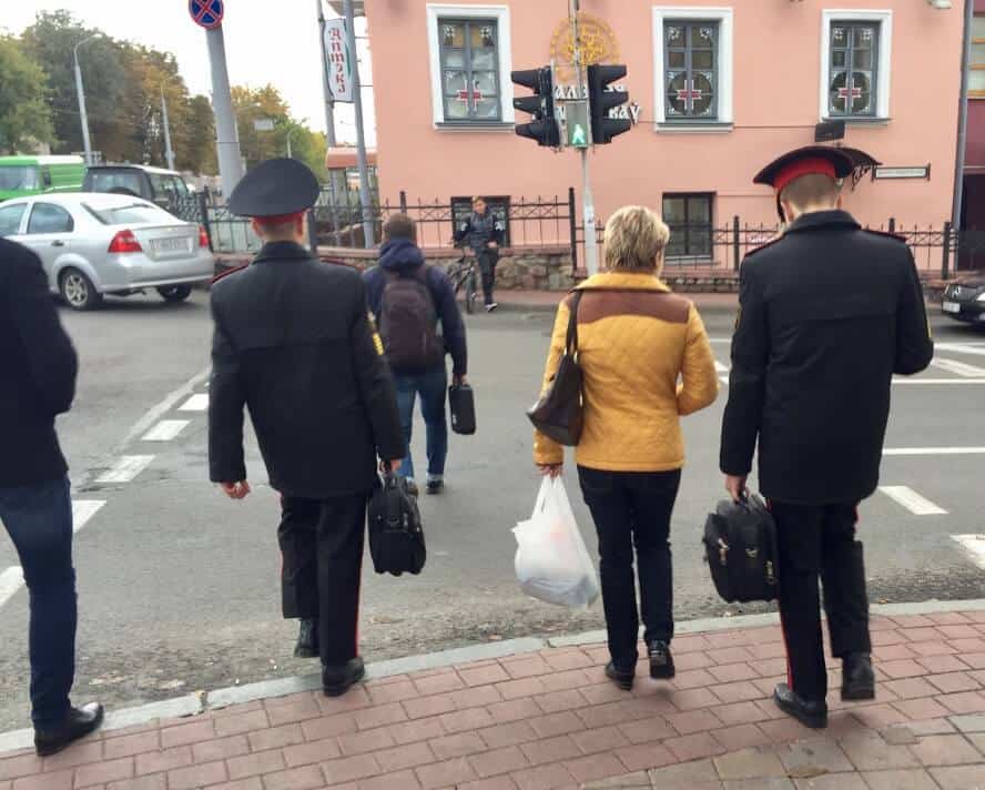 two Belarus police crossing the street 