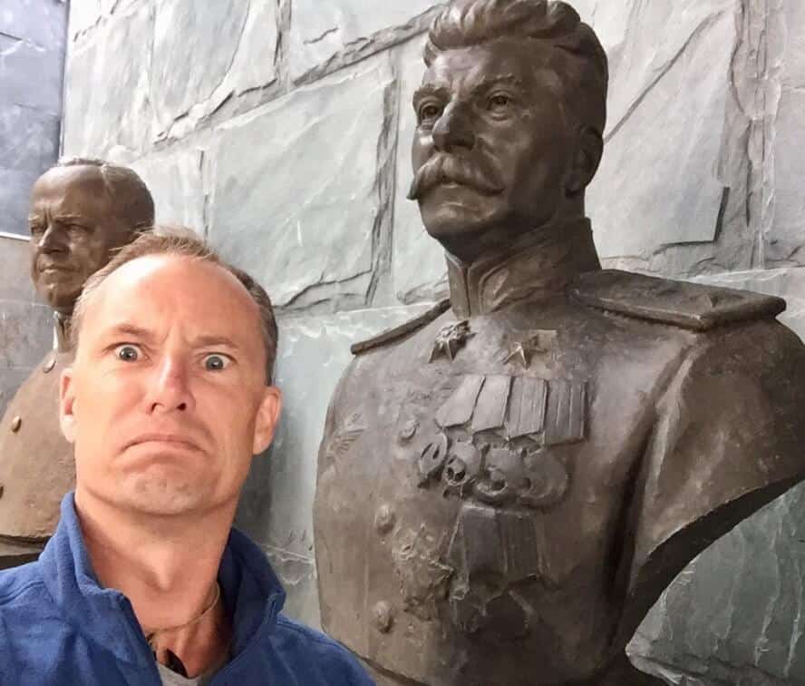 man with bust of Joseph Stalin