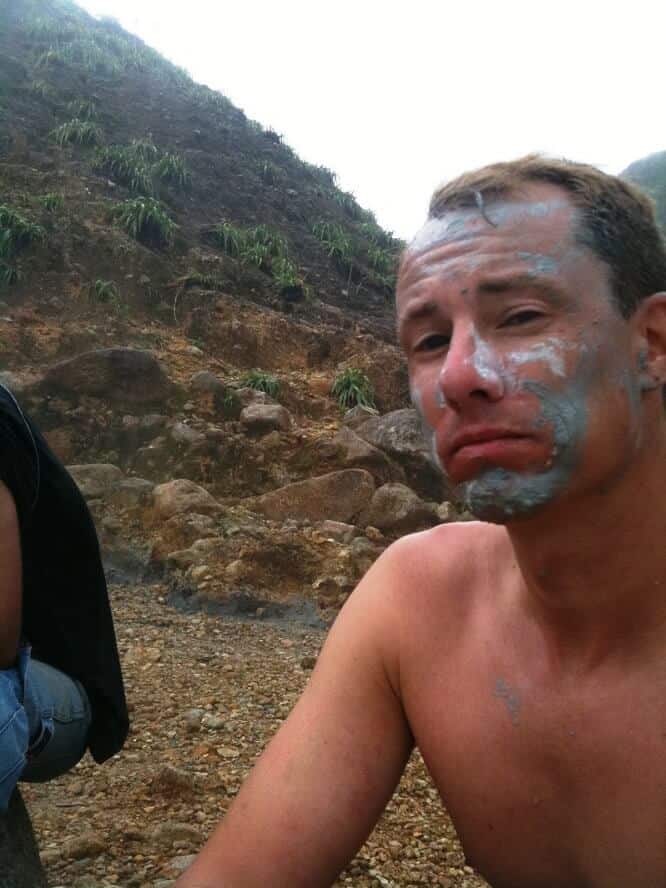 man with mud on his face on dominica tours