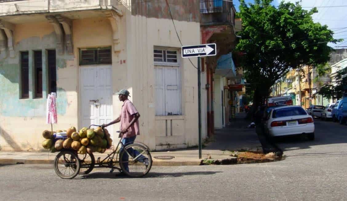 man on bicycle with coconuts