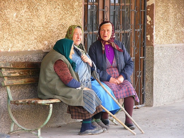 three bulgarian old ladies on a park bench