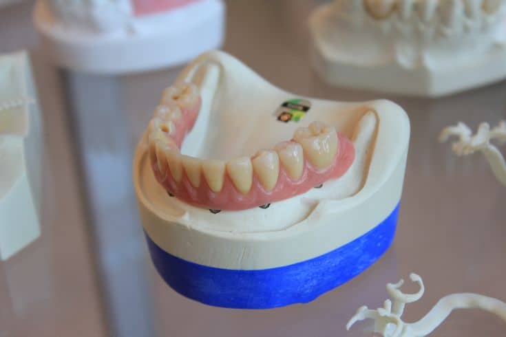 false teeth on a glass table