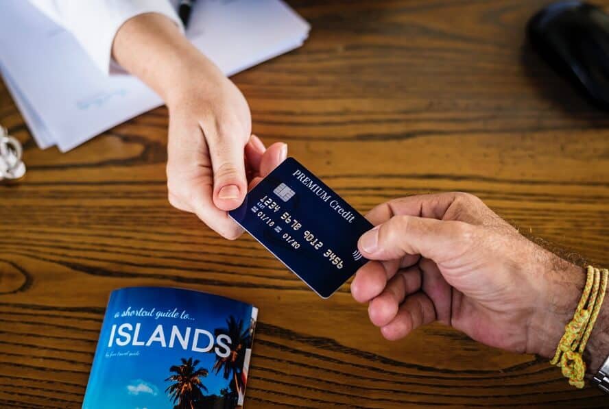 person handing credit card to person 