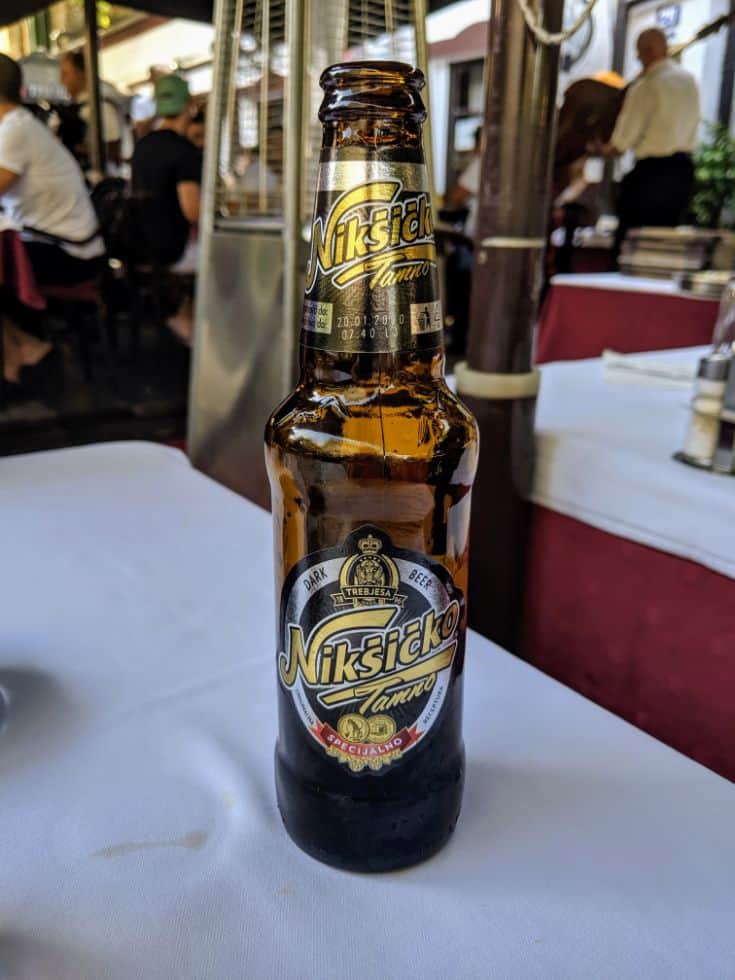 brown bottle of Niksicko beer on table in Serbia