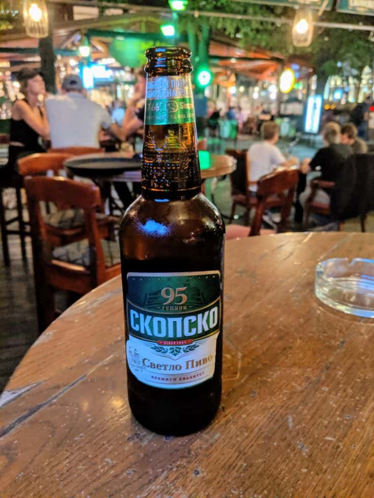 a brown Shopsko beer bottle on a table in a bar in Skopje