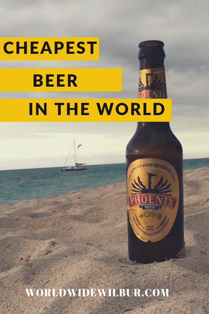 brown Phoenix beer bottle on a beach