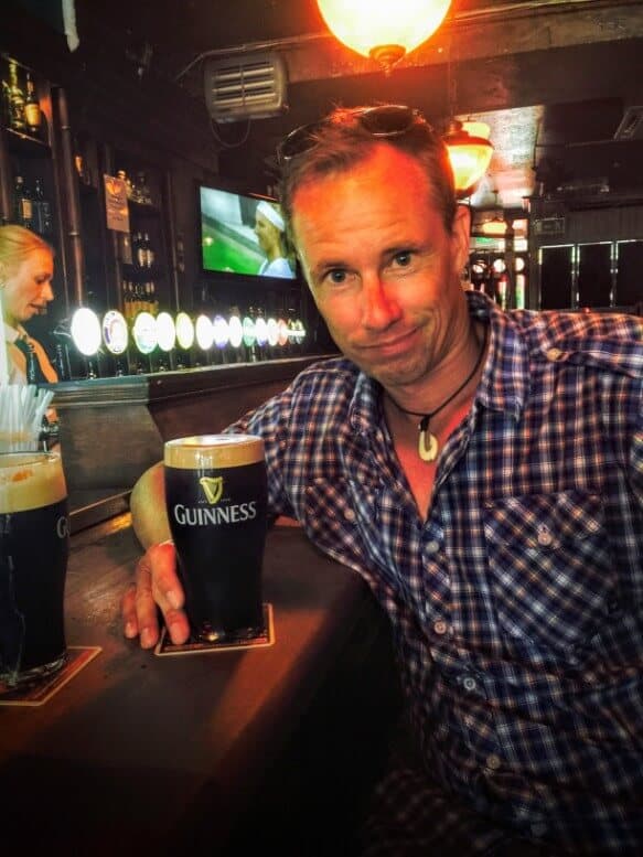 man with Guinness Pint in bar in Dublin