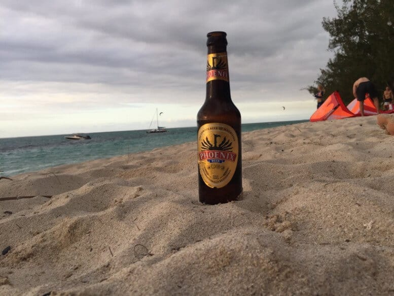 brown bottle of Phoenix beer on a Mauritius beach