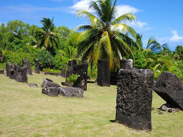 Badrulchau Stone Monoliths big rectangular stones in field with palm trees