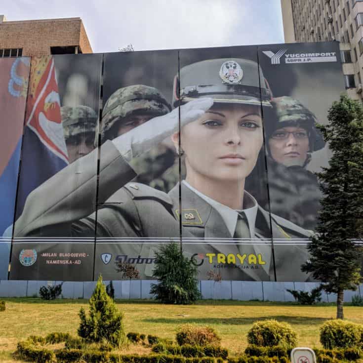 female soldier saluting on billboard