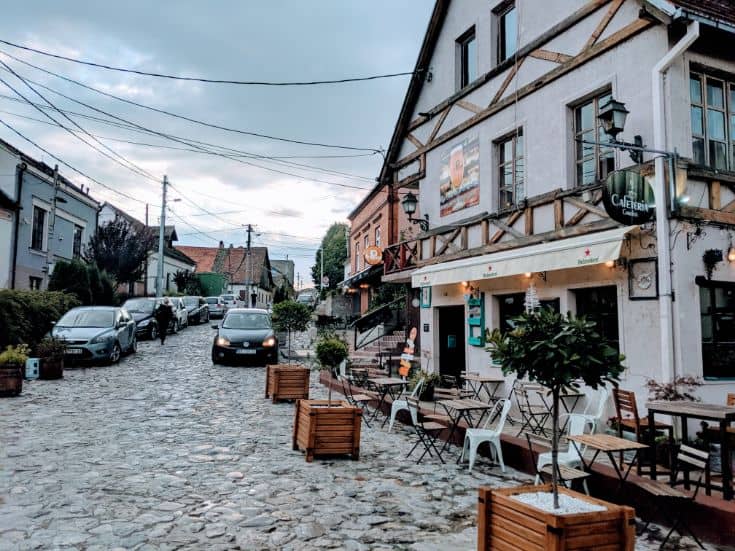 cobblestoned streets of zemun with old house and cars