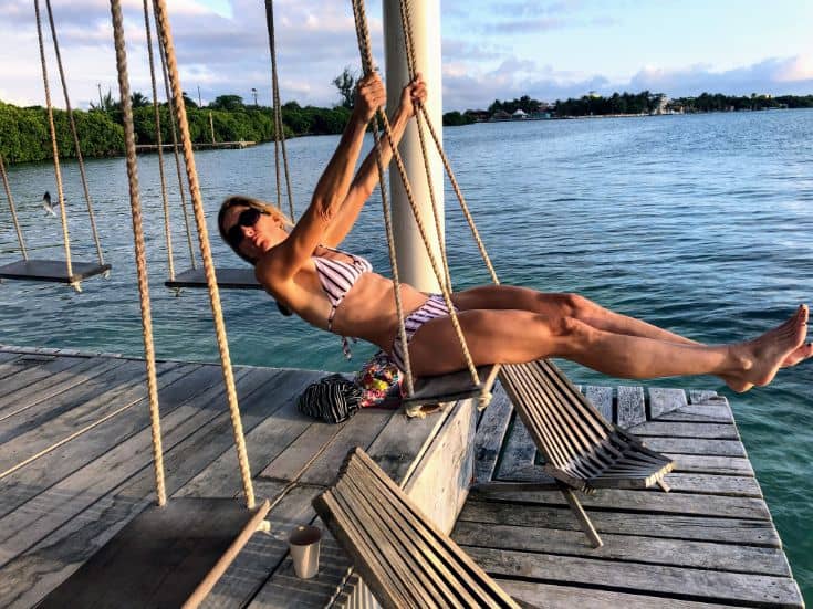 woman on swing over ocean