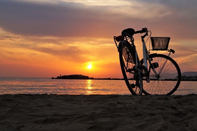 bicicleta pe plajă la apus