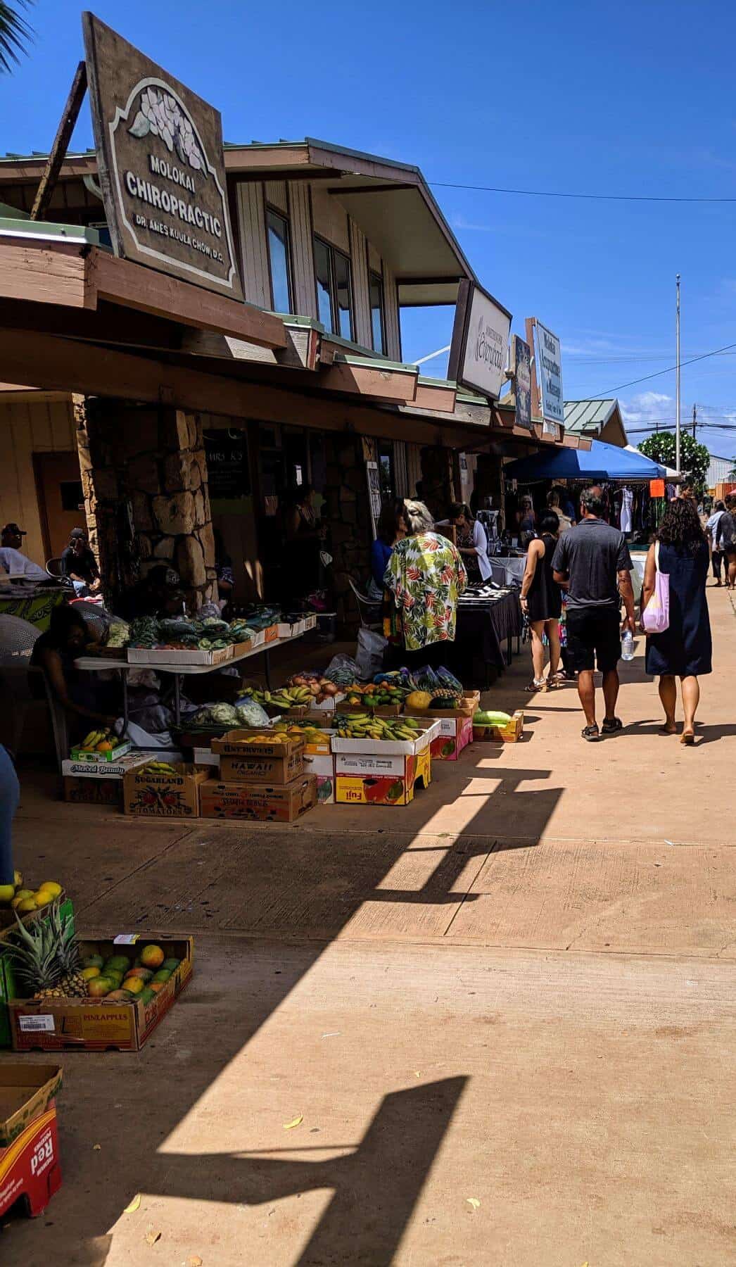 people walking through farmers market