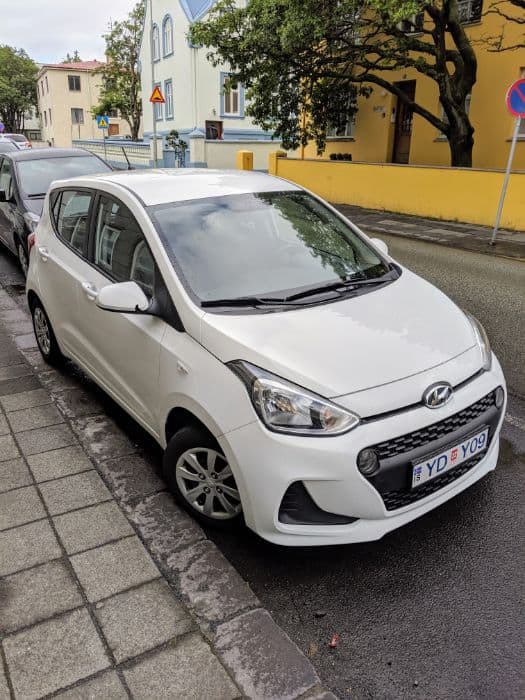 small white car on road Travel to Iceland on a Budget