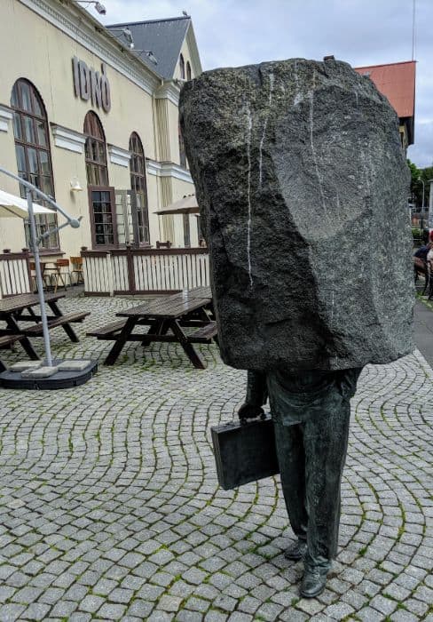 statue of a man encased in stone Iceland on a Budget