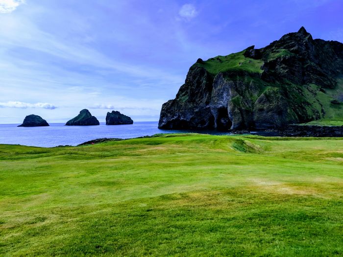 green fields and islands in ocean