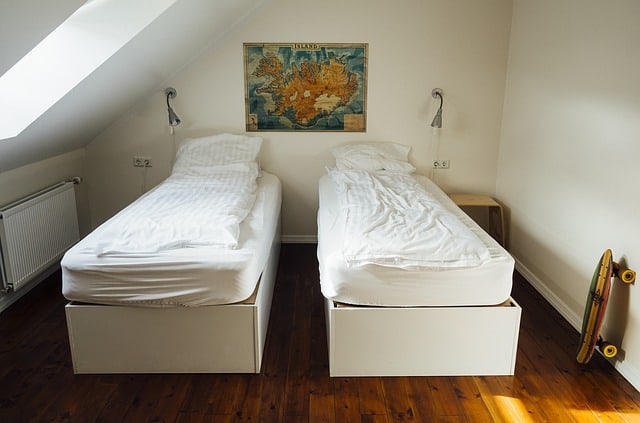 bedroom with two single beds Travel to Iceland on a Budget
